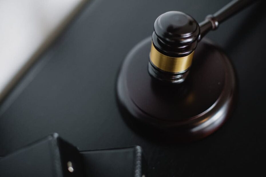 A dark brown gavel on a black desk